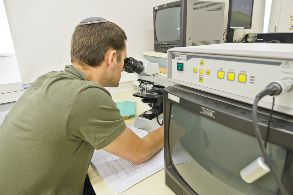 student with a microscope