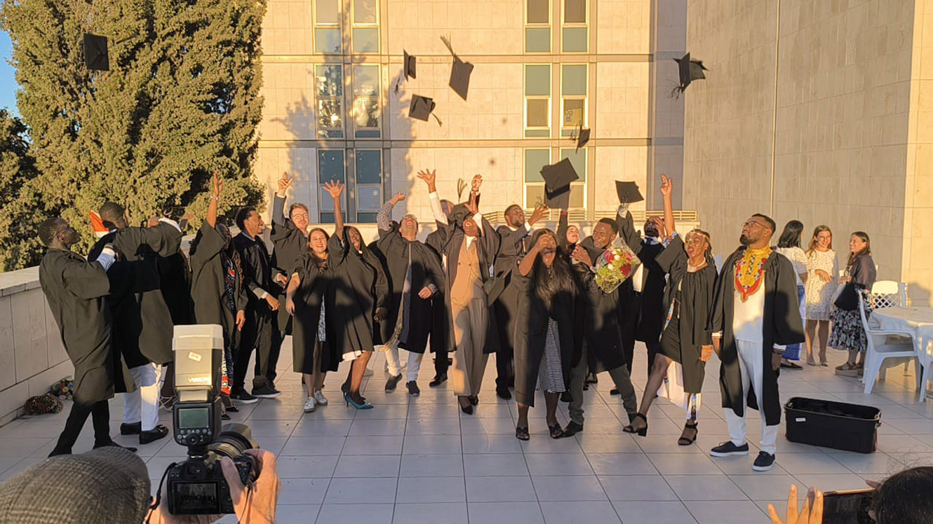 Graduates throw up their graduation caps celebrating their major achievements over the past year